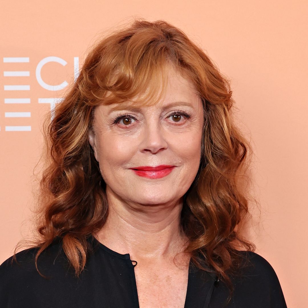 Susan Sarandon is a vision in all white as she cozies up to dashing A-lister