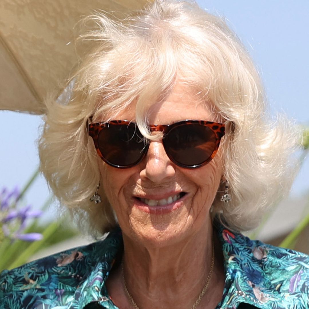 Duchess Camilla looks so chic in silky dress and shades as she steps off the plane