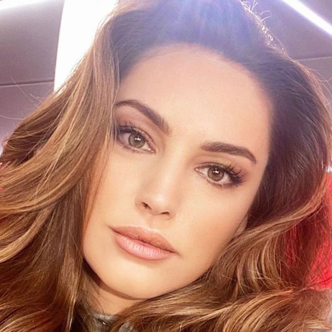 Kelly Brook puts a fresh spin on winter workwear in mini dress and knee-high boots