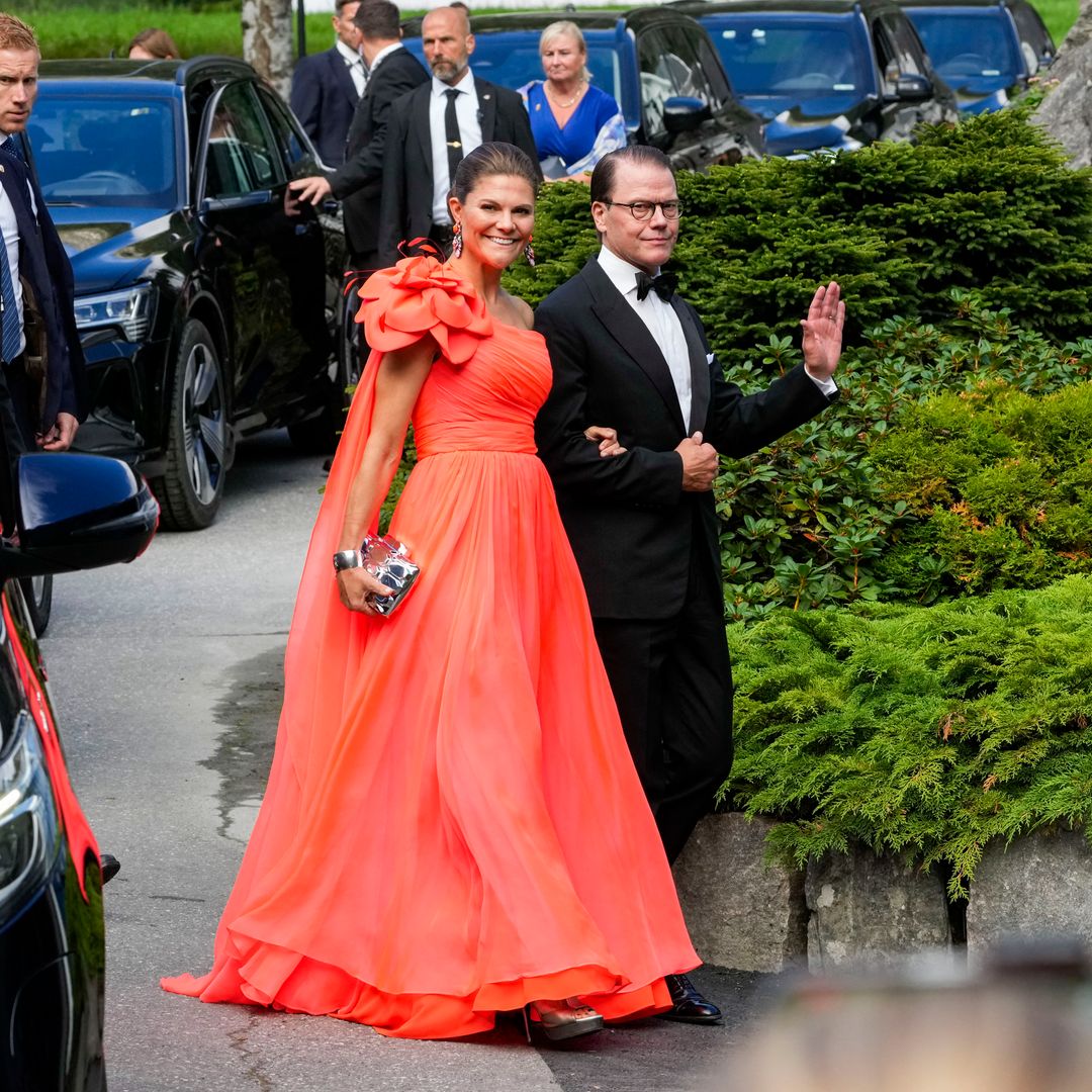 Crown Princess Victoria displays toned arms in coral one-shoulder gown