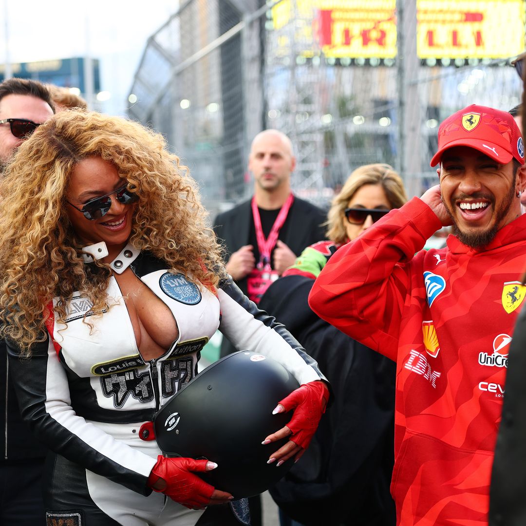 The singer laughs with Lewis Hamilton on the hot laps grid prior to the Grand Prix