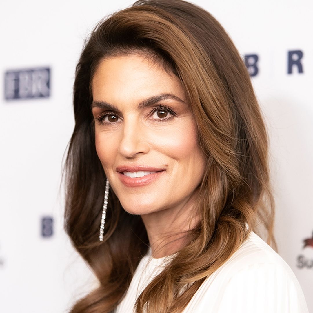 Cindy Crawford nails preppy chic in flippy mini skirt and knit