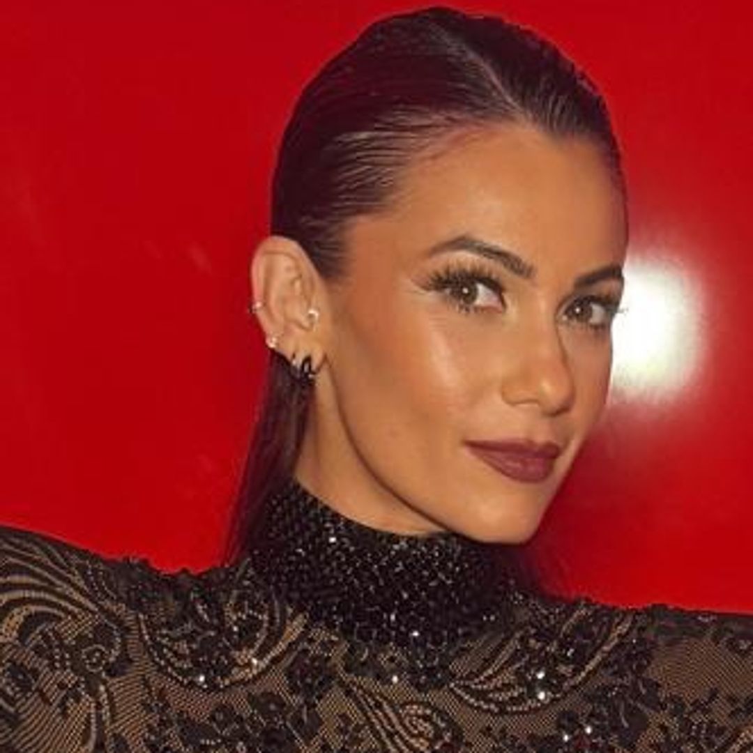 Dianne Buswell displays baby bump in sheer catsuit: 'He's certainly grown'