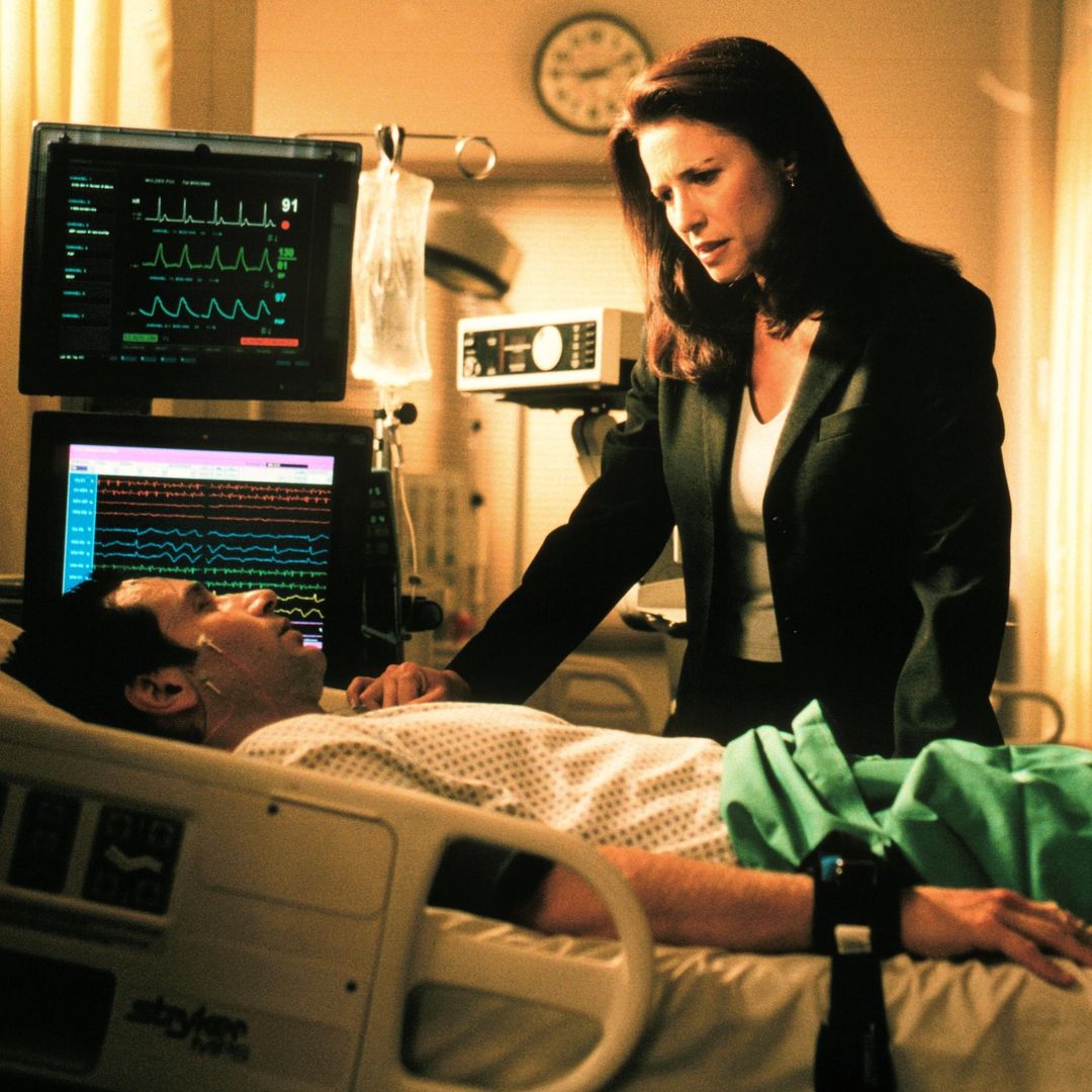 THE X-FILES - SEASON 7: Agent Diana Fowley (Mimi Rogers, R)  stands by Agent Fox Mulder's (David Duchovny, L) bedside in "The Sixth Extinction" episode which originally aired Sunday, Nov. 7, 1999 on FOX