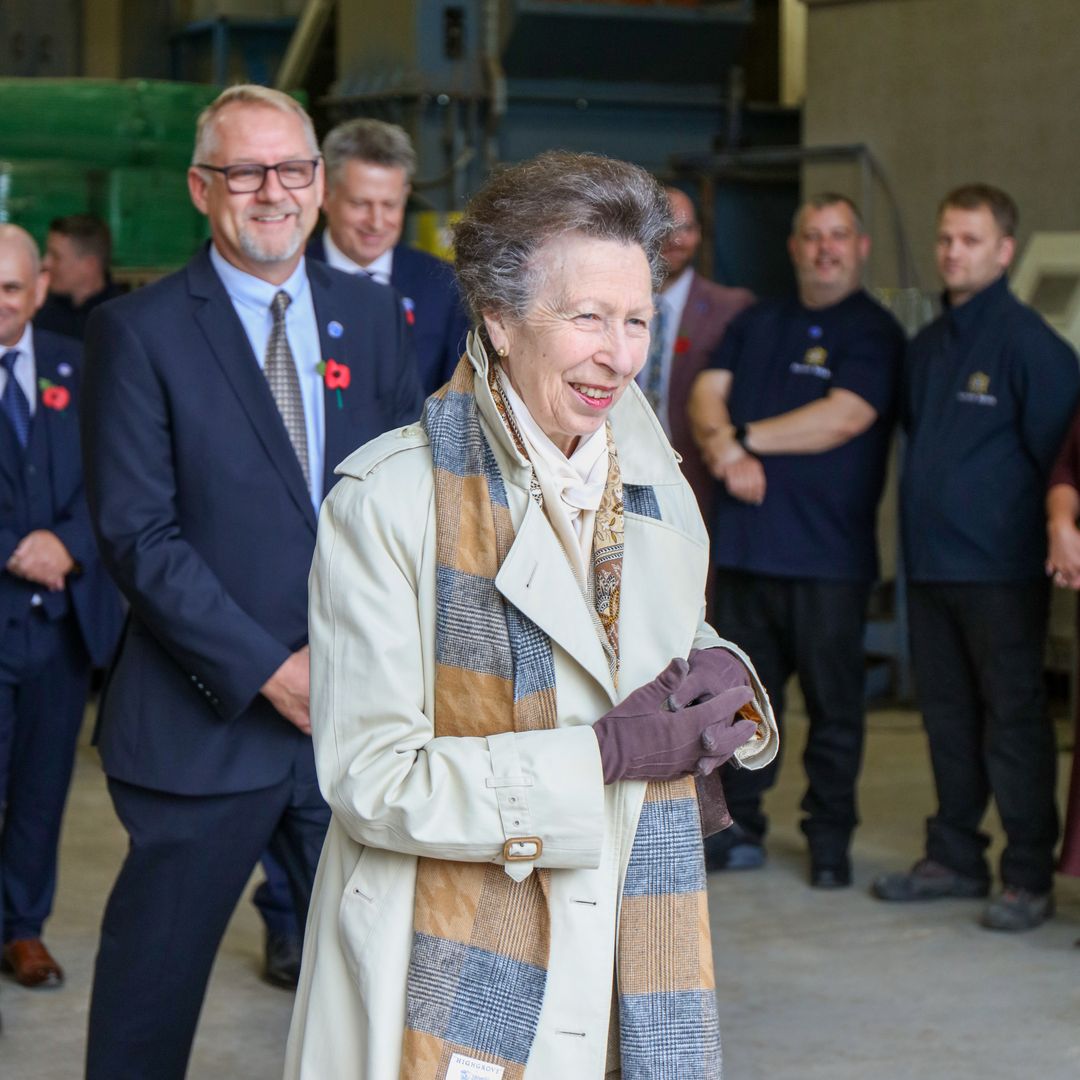 Princess Anne steps out in classic trench coat and special gift