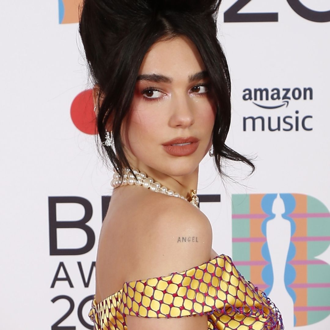 Dua Lipa slays the vacation game in pink wrap top and the wildest jeans