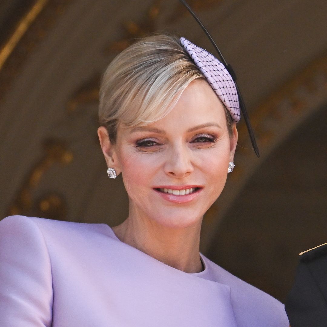 Princess Charlene rocks tartan scarf and killer £1.7k heels to deliver Christmas presents