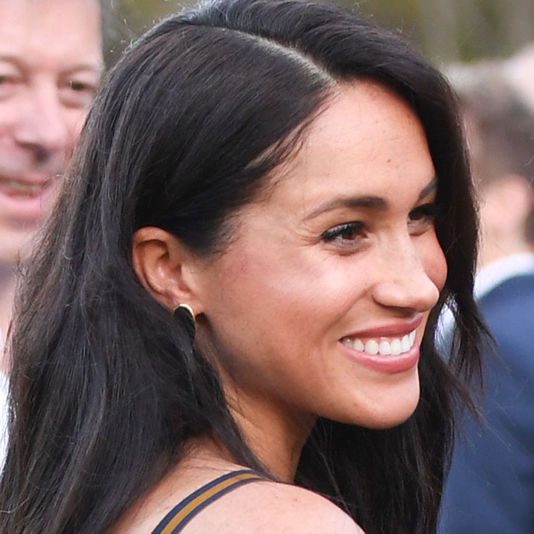 Meghan Markle turns heads in sheer Club Monaco dress as she carries baby Archie