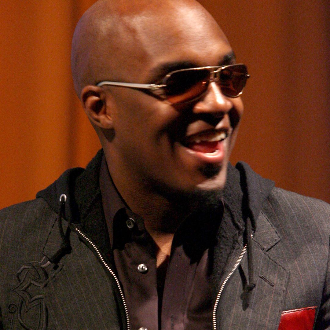 Damon Thomas smiling and looking to the right, he is wearing sunglasses