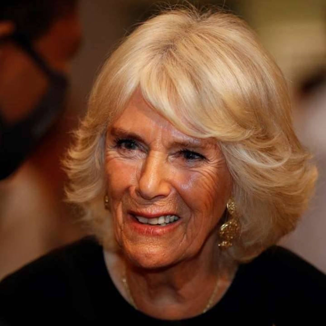 The Duchess of Cornwall looks stunning in pink leopard print blouse and trouser suit as she pays heartfelt tribute to libraries