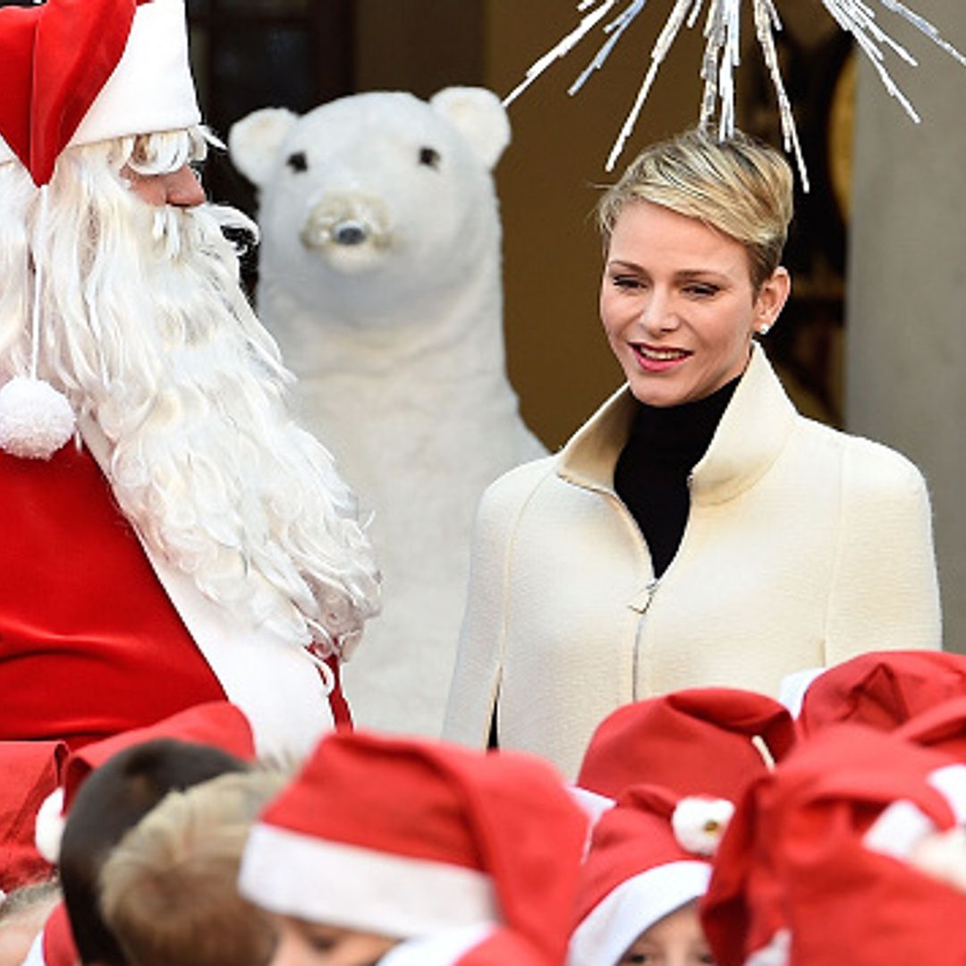 Princess Charlene and Prince Albert hand out presents to children in Monaco