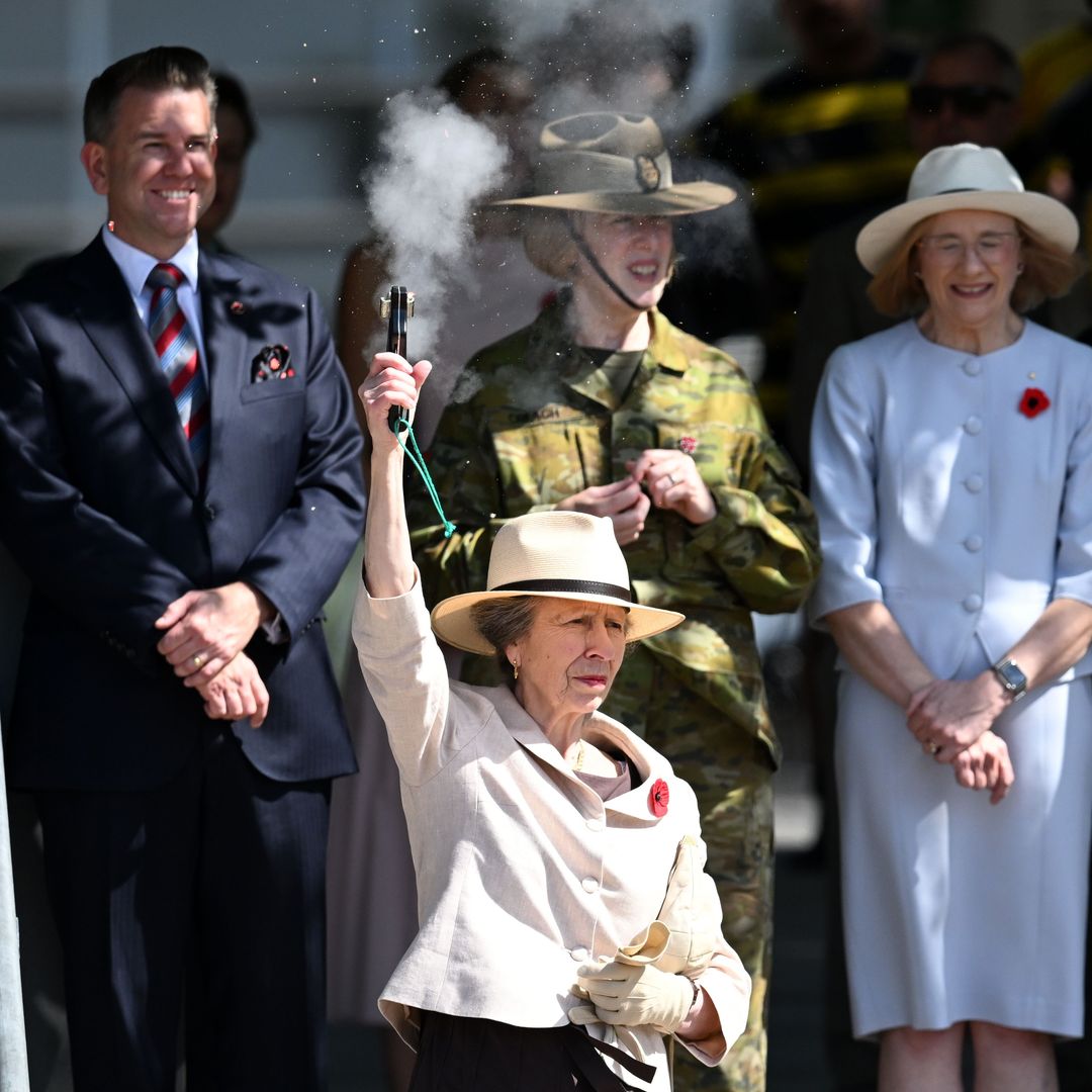 Princess Anne pictured firing a starting pistol during action-packed day in Australia