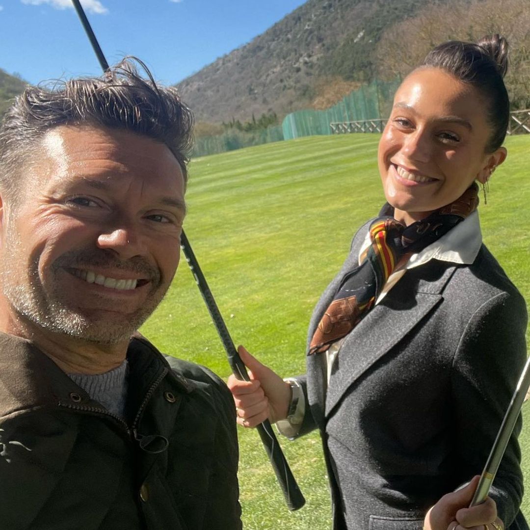 Ryan Seacrest and his girlfriend Aubrey pose for a selfie while golfing