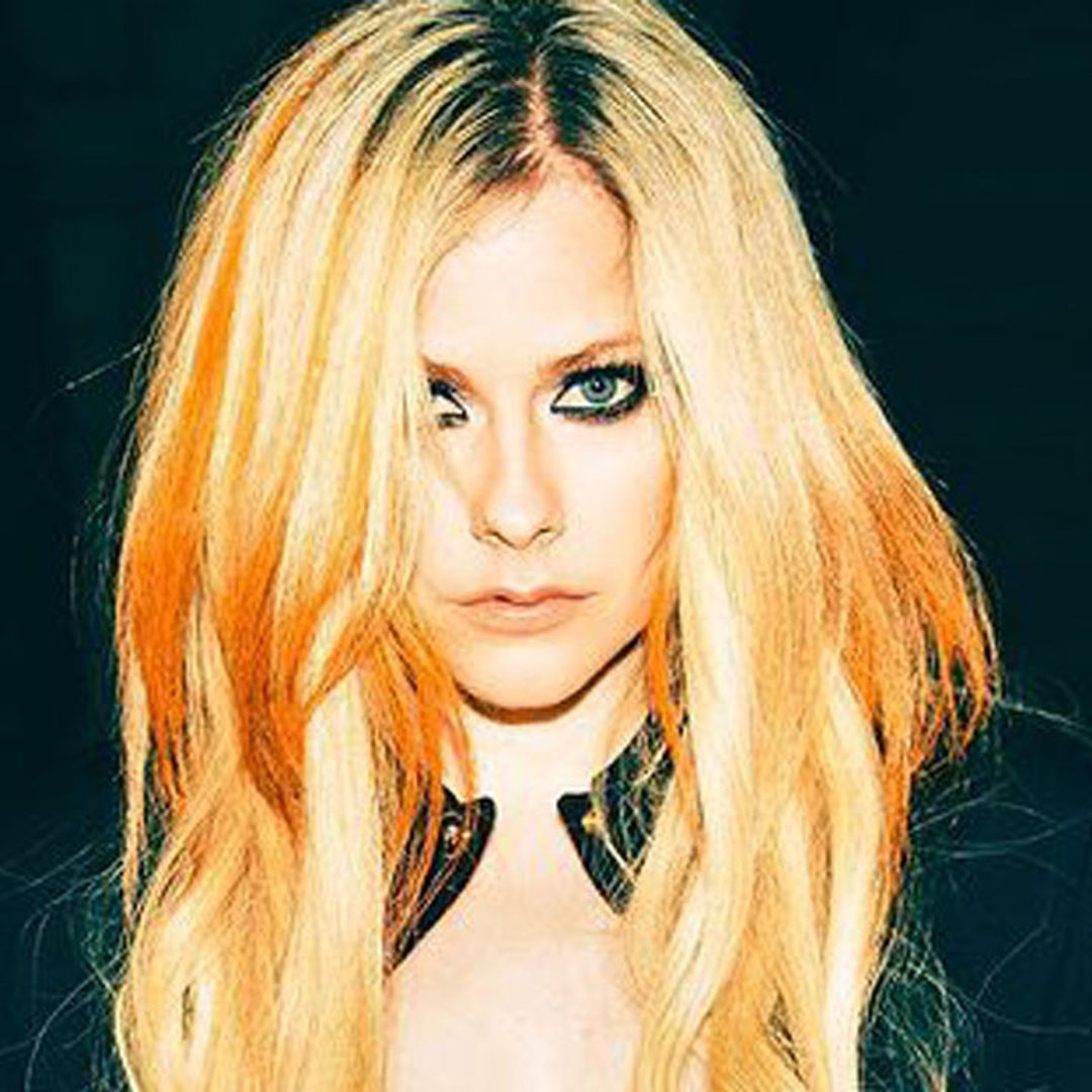 Avril Lavigne's fishnet and hotpants Versace look leaves fans reeling
