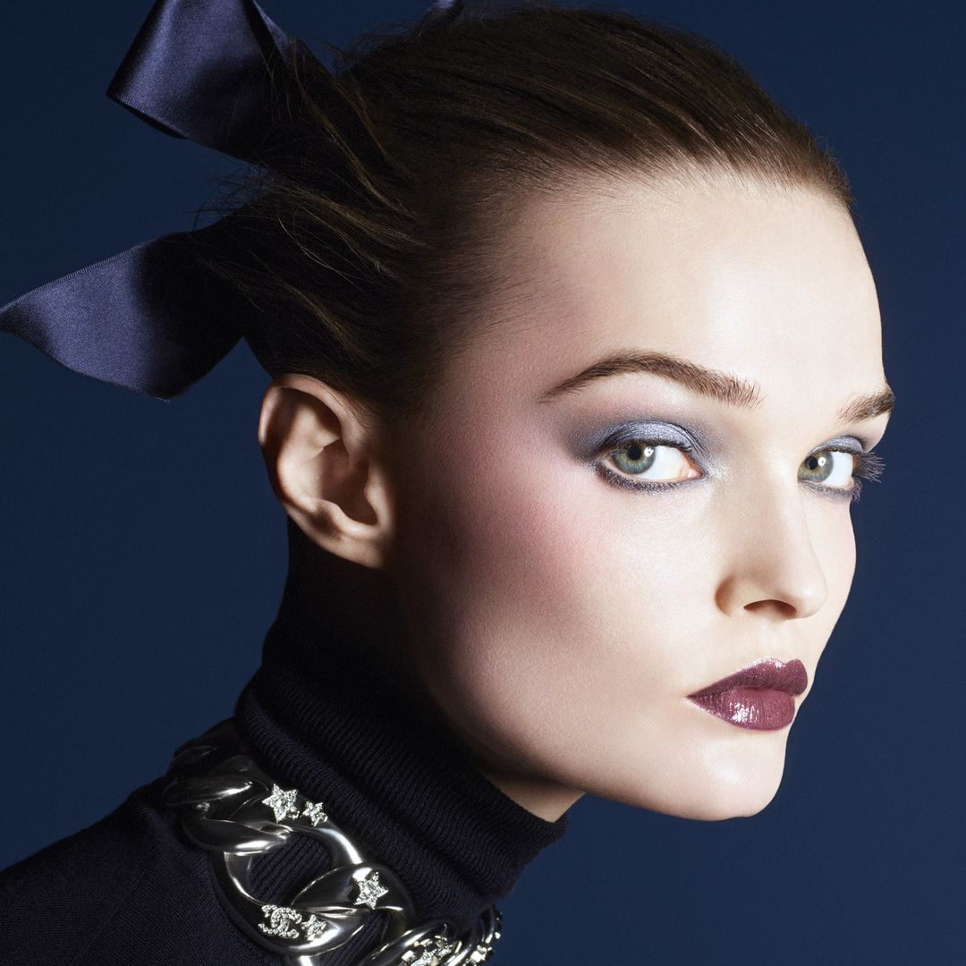 a woman with blue eyeshadow and red lips 