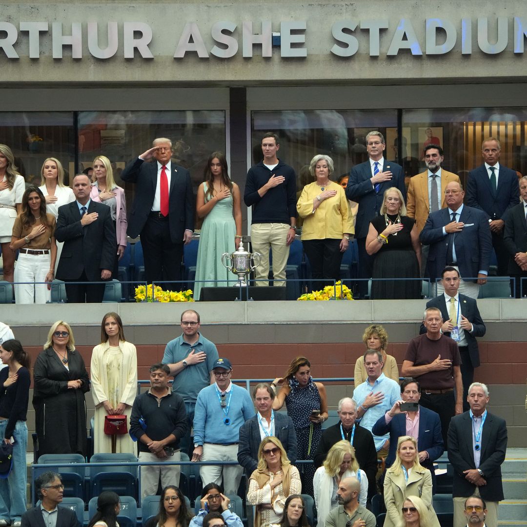 Surrounded by family and members of his cabinet, U.S. President Donald Trump salutes during the singing of the National Anthem before the start of the U.S. Open men's singles final at the Billie Jean King National Tennis Center for the U.S. Open finals on September 7, 2025 in New York City. President Trump is attending the U.S. Open menâs singles final between Carlos Alcaraz and Jannik Sinner