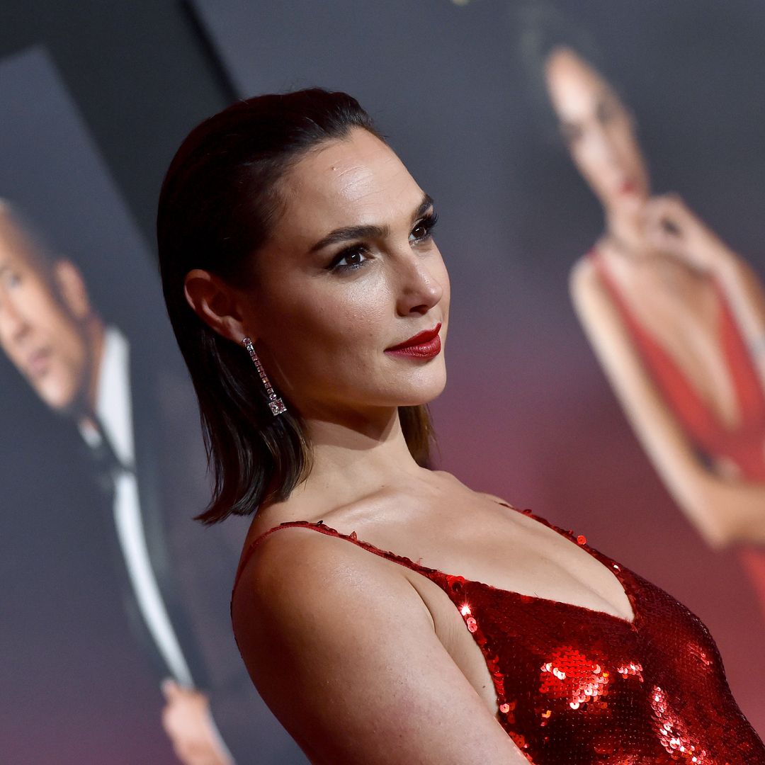 Gal Gadot shows off her action hero physique in a sheer dress and underwear