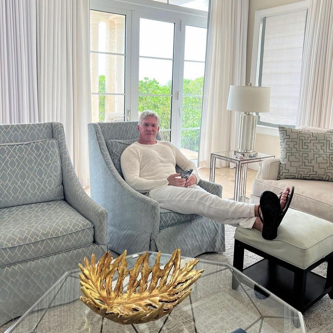 Sam Champion reclining on a chair with his feet up, looking relaxed
