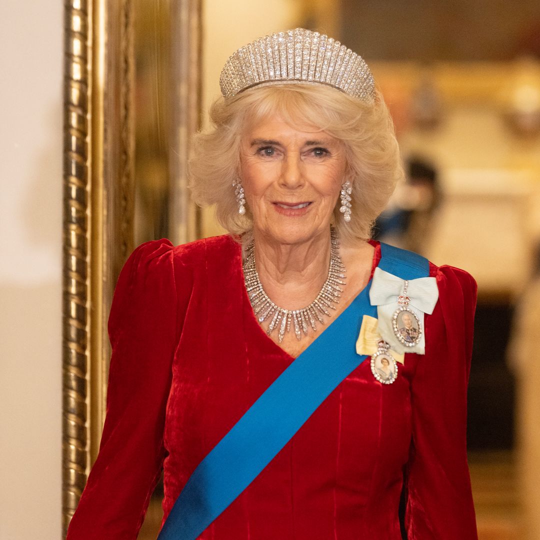 Queen Camilla just wore a striking caped dress in this season's top colourway