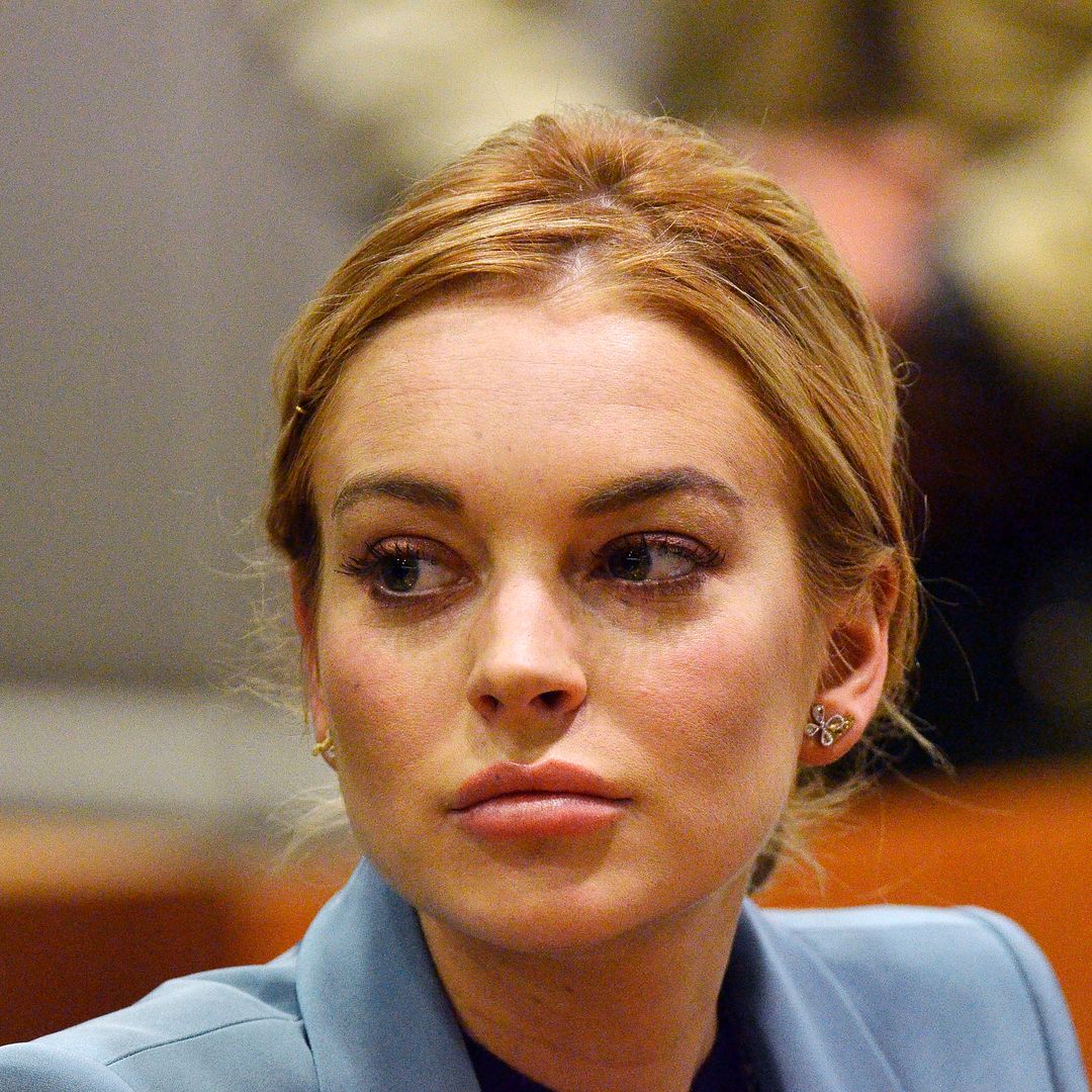 Lindsay Lohan sat looking to her right thoughtfully