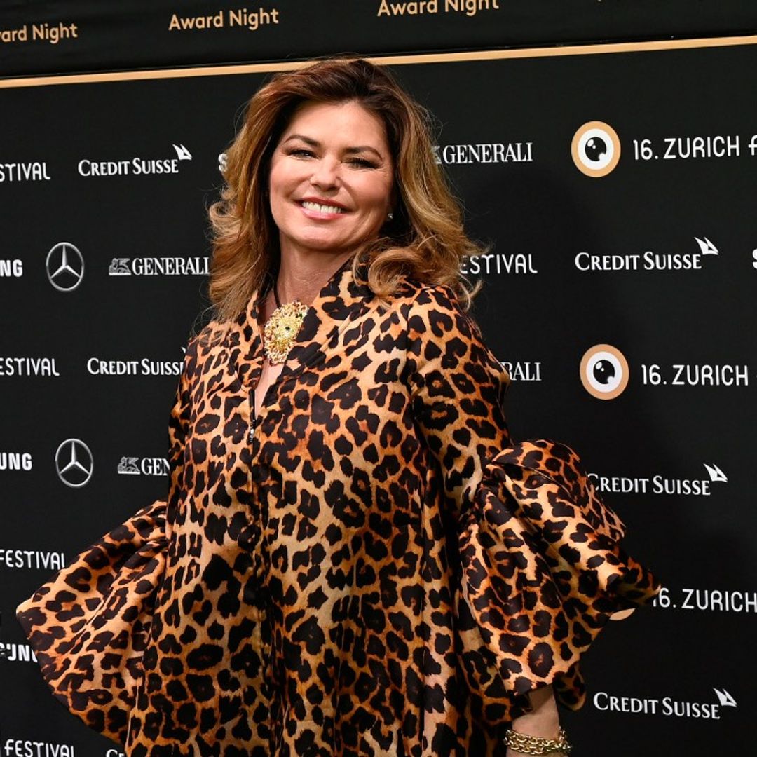 Shania Twain looks fabulous in sparkly mini dress and knee-high boots