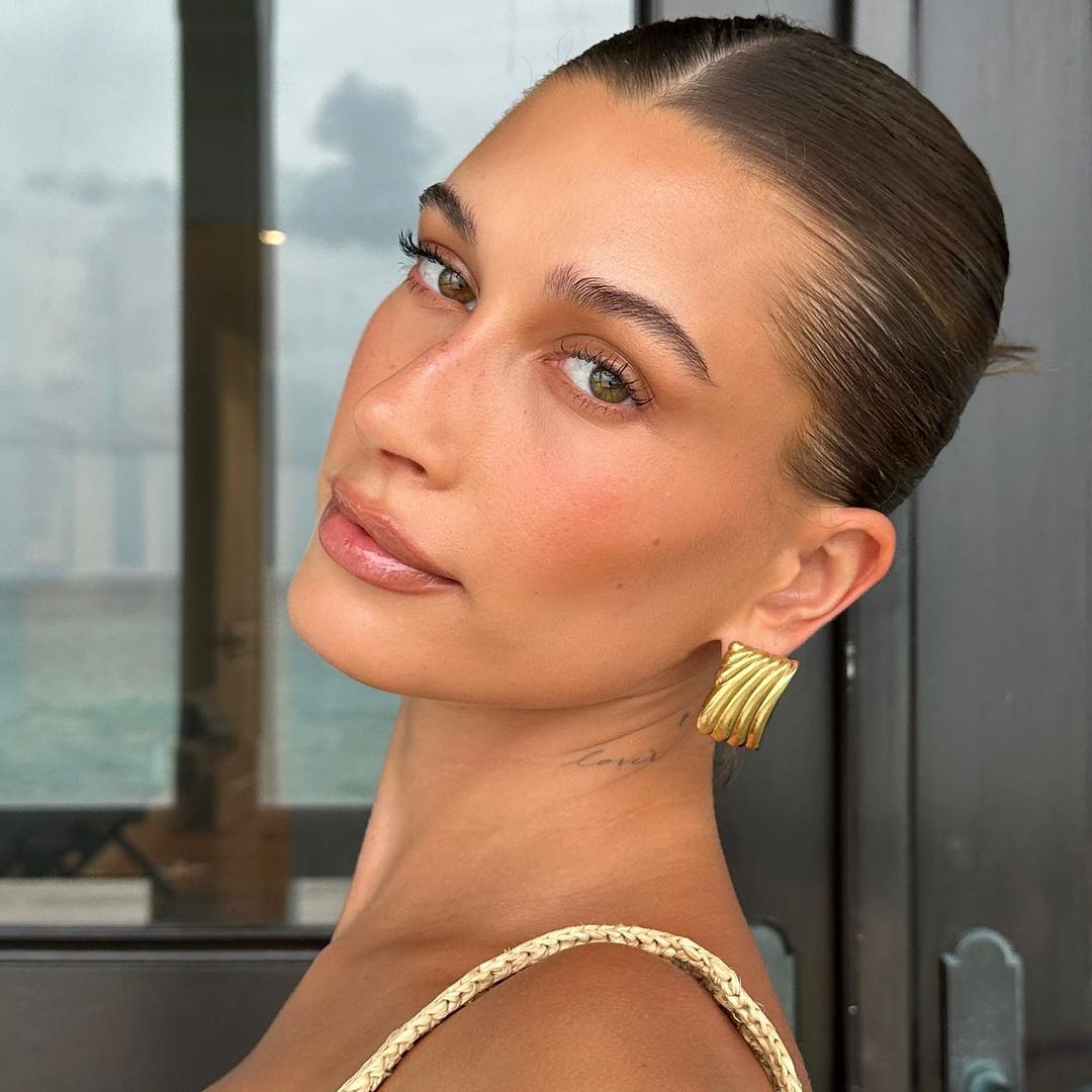 Hailey Bieber coins it a 'lemon drop summer' in capri pants and a matching bikini top