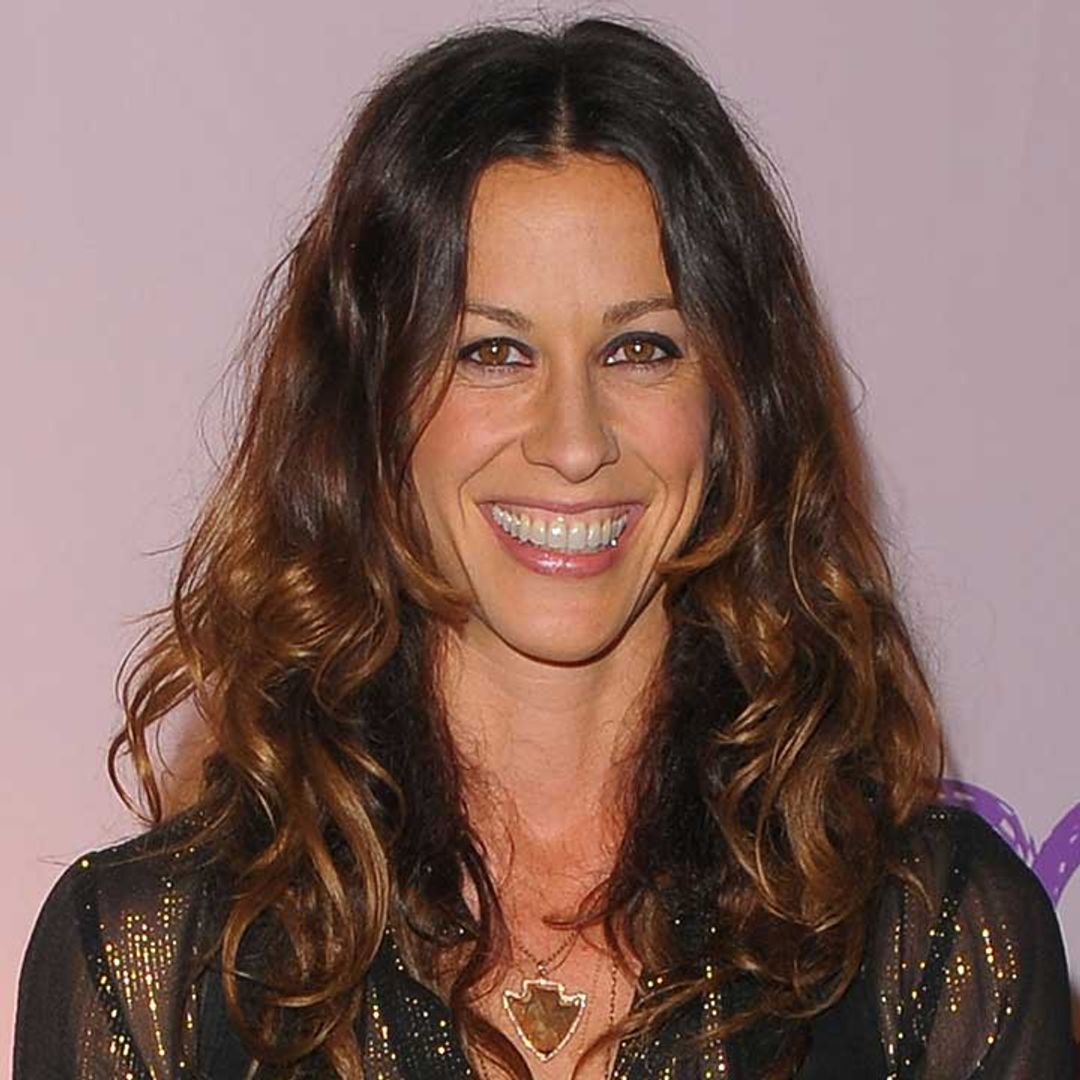 Alanis Morissette shares a rare photo of her family as she's snapped breastfeeding her son