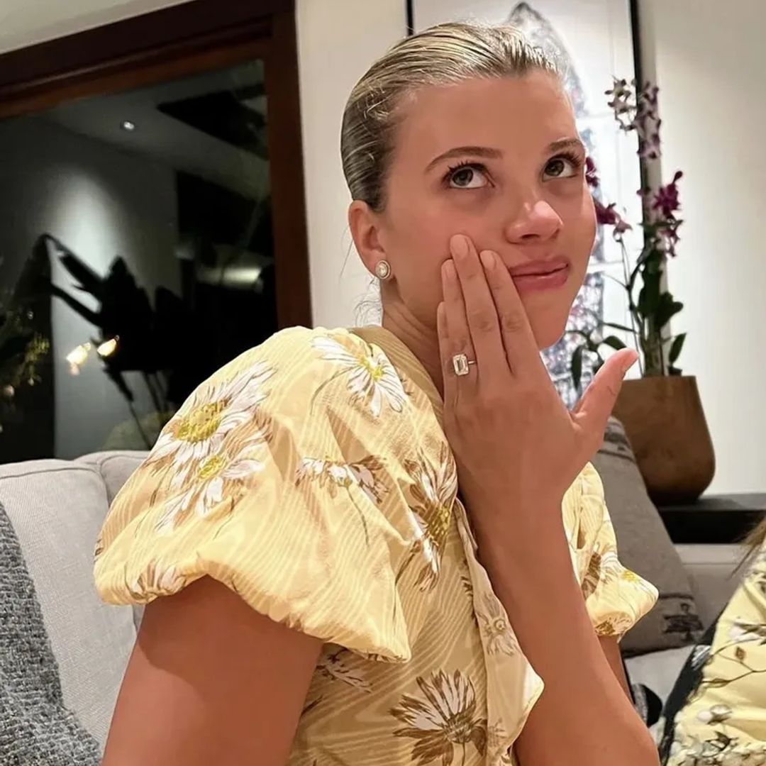 Sofia Richie showing off engagement ring in yellow dress
