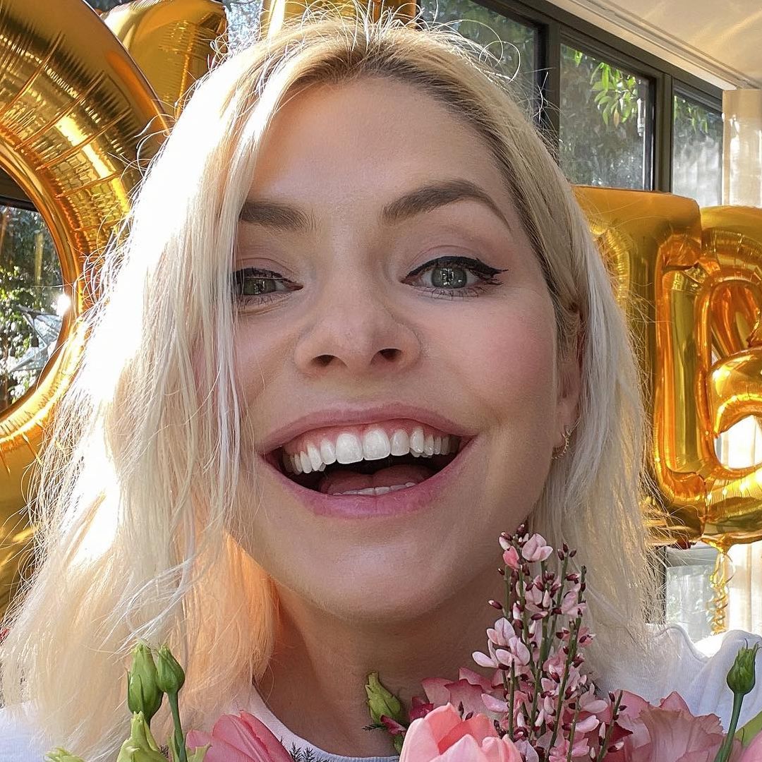 Bronzed Holly Willoughby re-emerges in feminine dress for new appearance