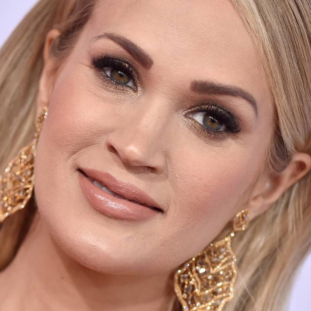 Carrie Underwood is holiday-ready in bejeweled red gown as she announces special news