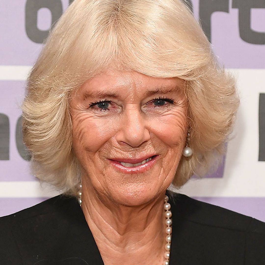The Duchess of Cornwall oozes style in on-trend black cape