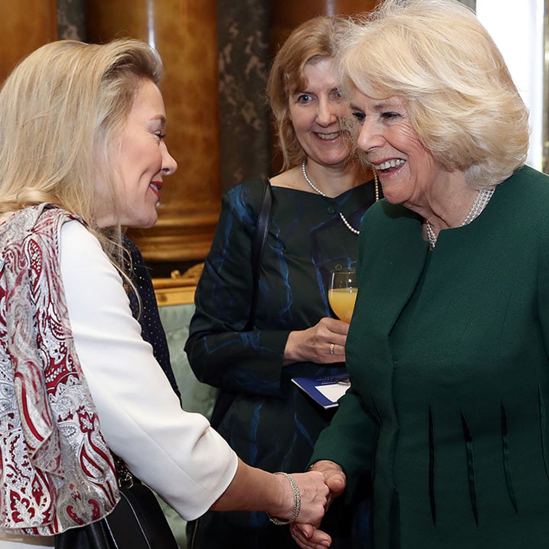 The Duchess of Cornwall is glamorous in green as she hosts University winners at Buckingham Palace 