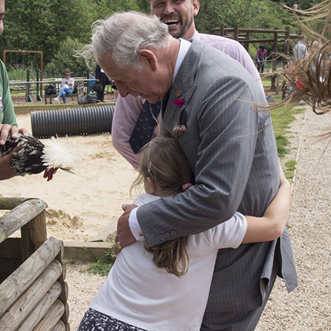 Prince Charles given huge hug by 8-year-old royal fan on farm visit
