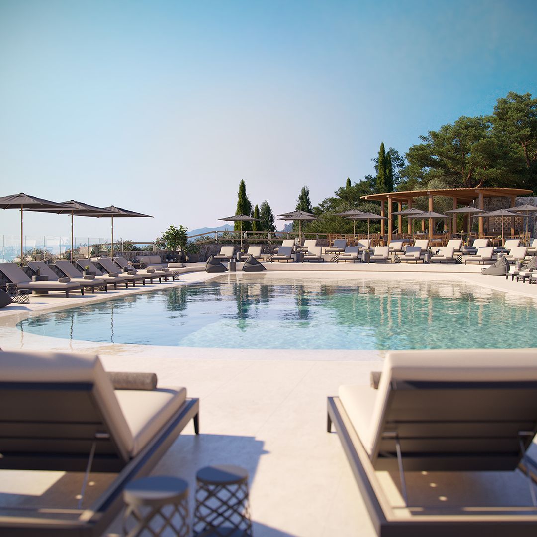 sun beds by the pool with blue sky backdrop