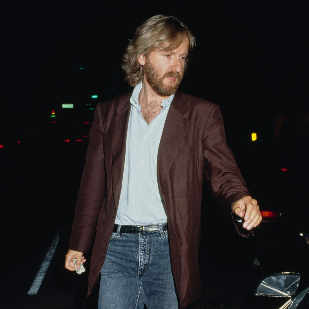 Canadian film director and screenwriter James Cameron wearing a brown blazer over a light blue shirt with jeans, circa 1985.