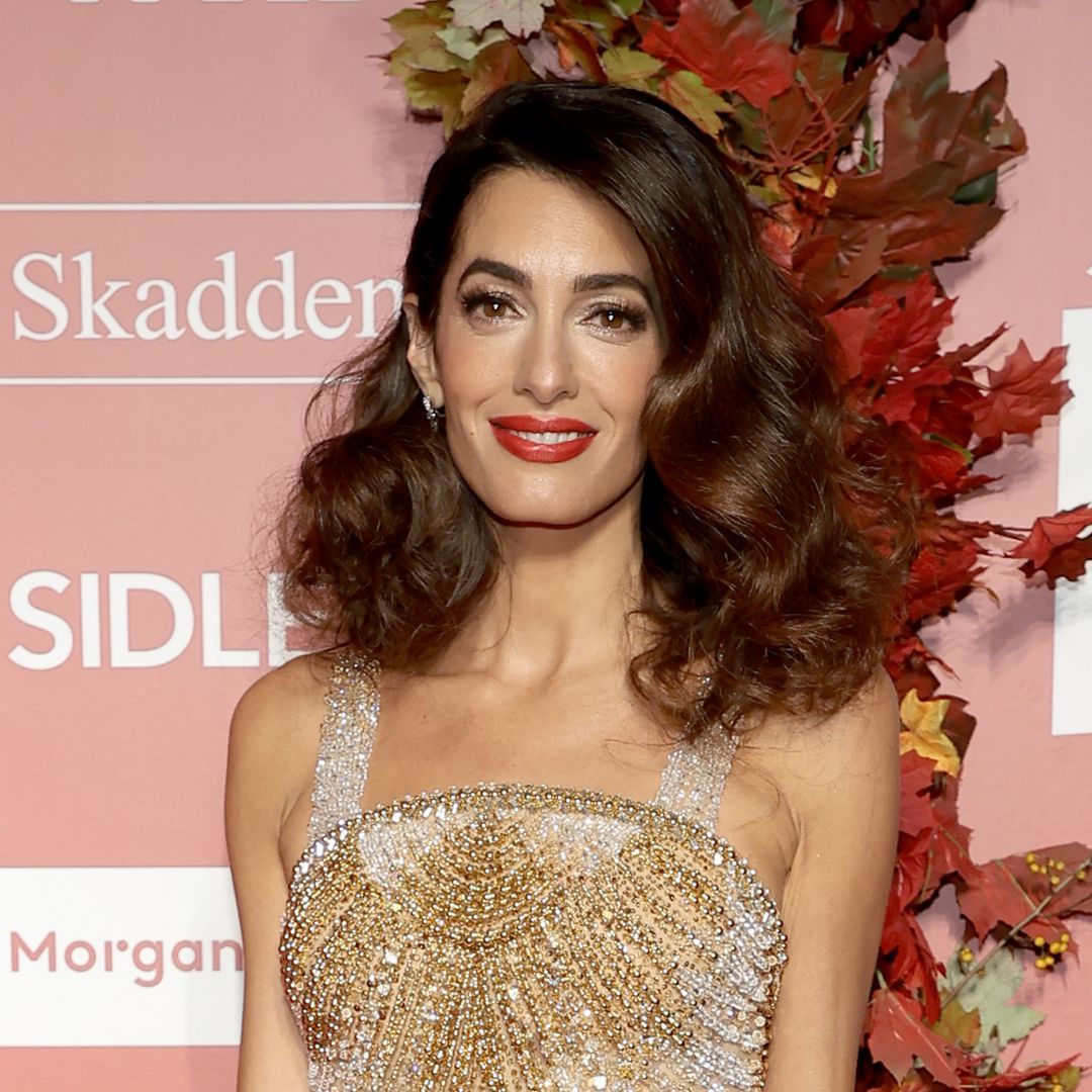 Amal Clooney showcases incredible physique in blinding low-cut mini dress