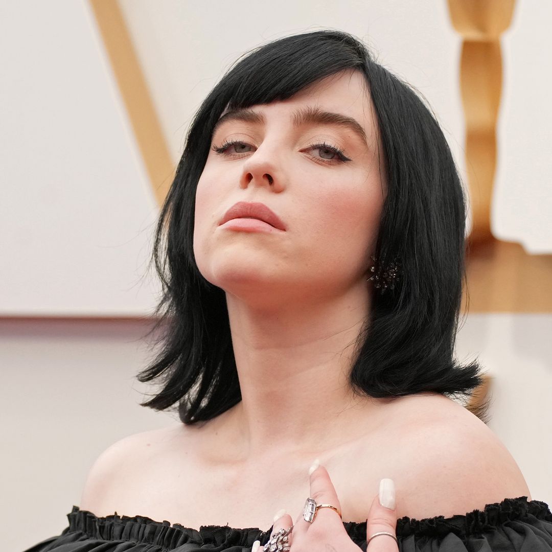 Billie Eilish poses in sheer tights and little black dress for sultry new photo