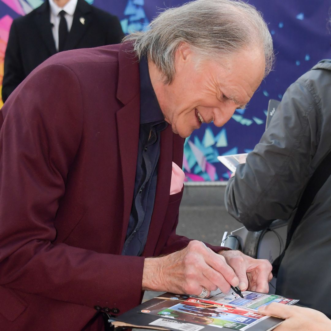 David Bradley signing an autograph for a fan