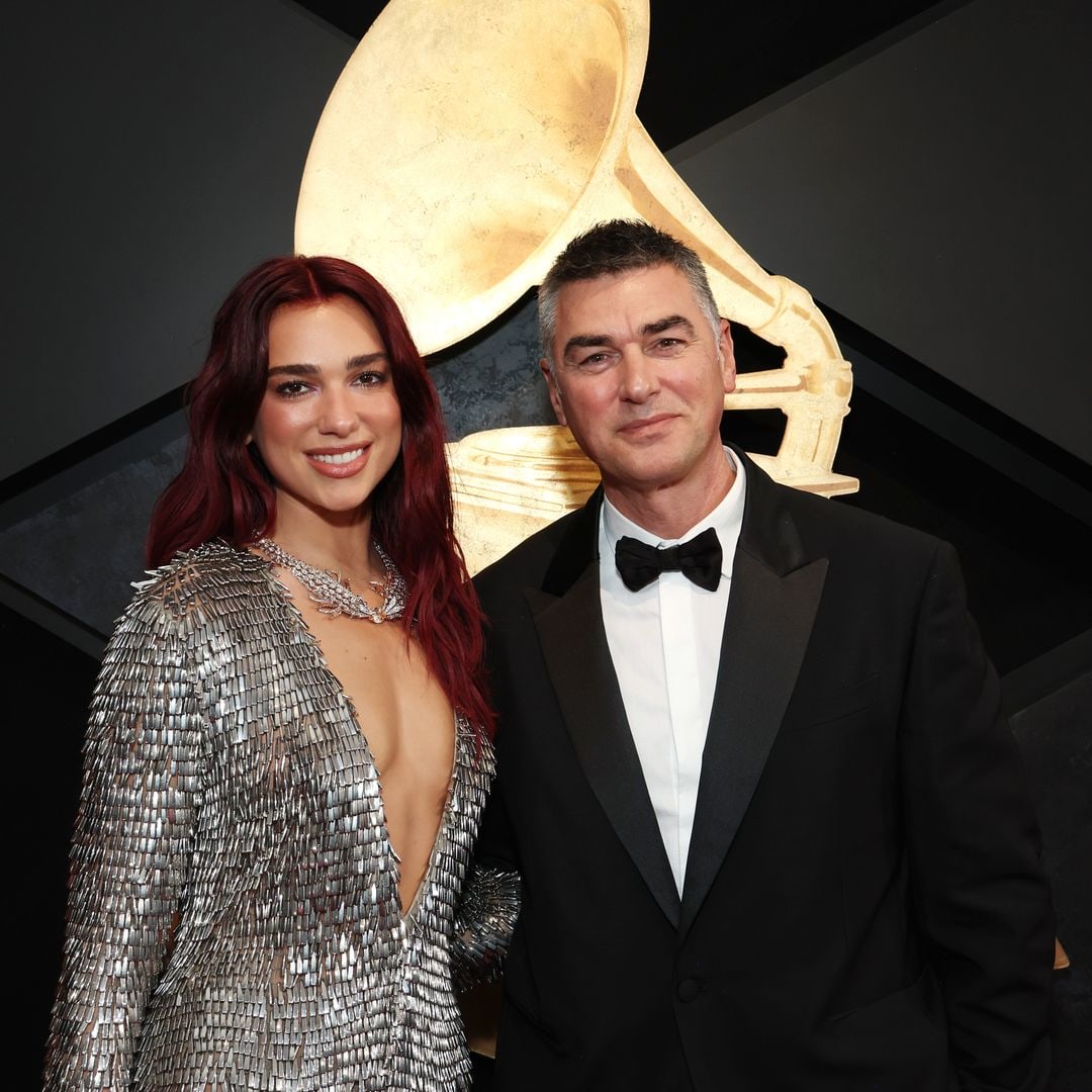 Dua Lipa stuns in a plunging silver gown as she makes rare appearance with dad at Grammys