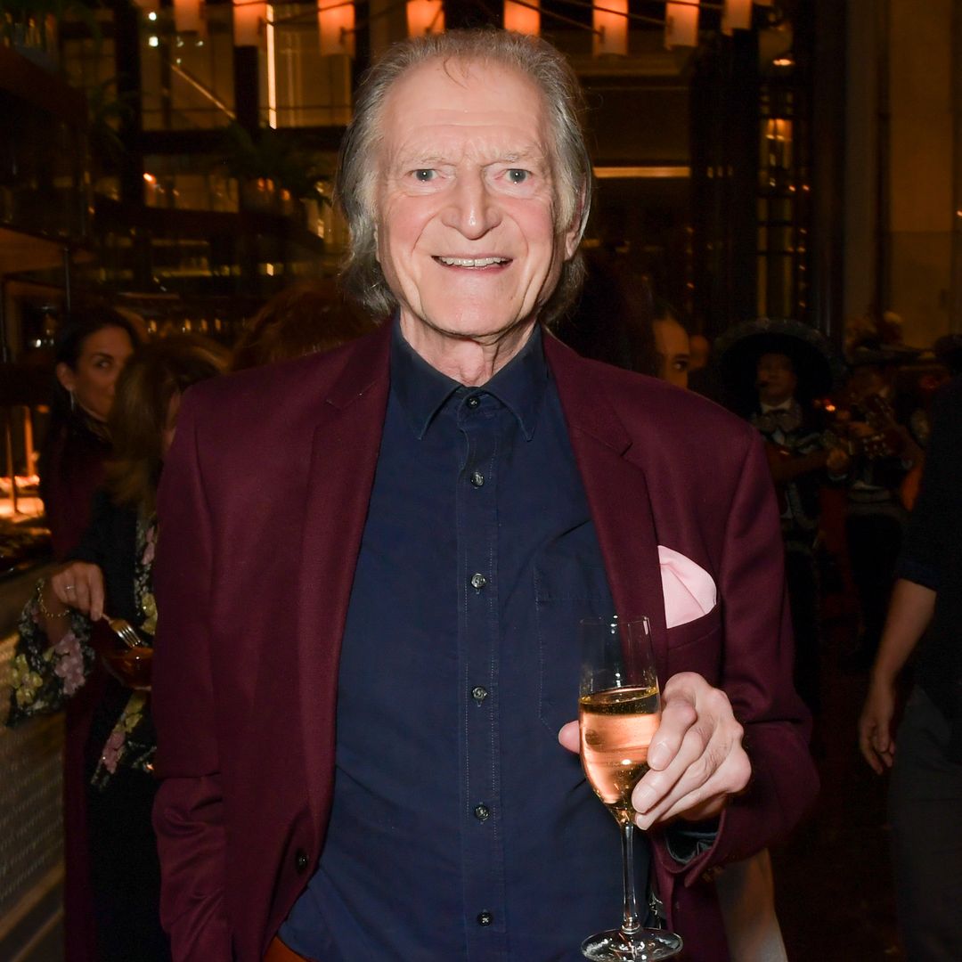 David Bradley smiling and holding a glass of wine