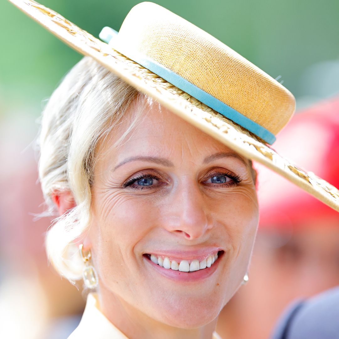 Zara Tindall is elegance personified in waist-cinching silk dress and straw boater hat
