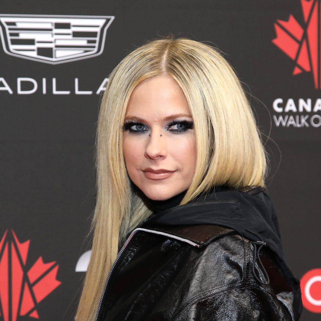 Avril Lavigne stuns in asymmetrical mini skirt with the tiniest appearance change you might've missed as she reunites with ex-husband
