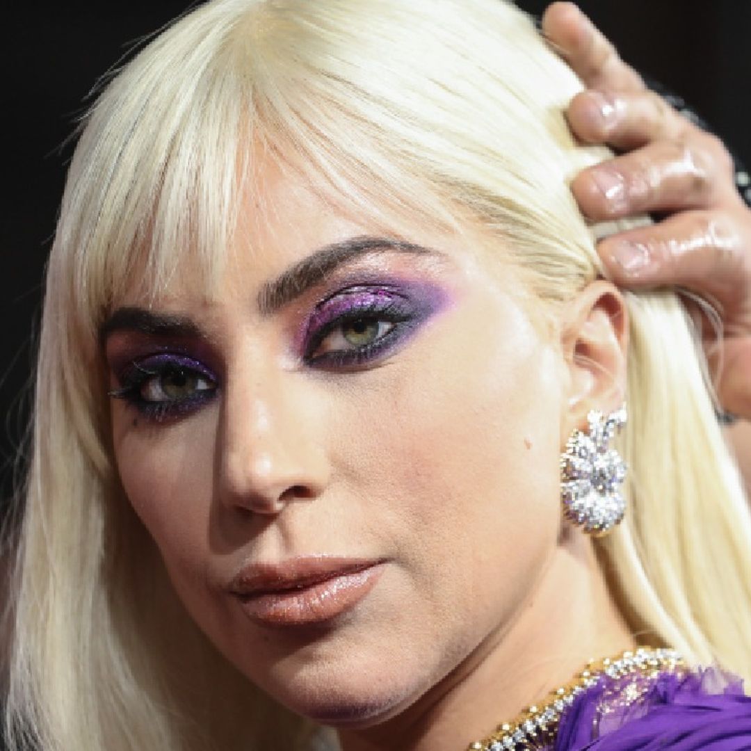 Lady Gaga looks phenomenal in bold red lip and metallic stage attire