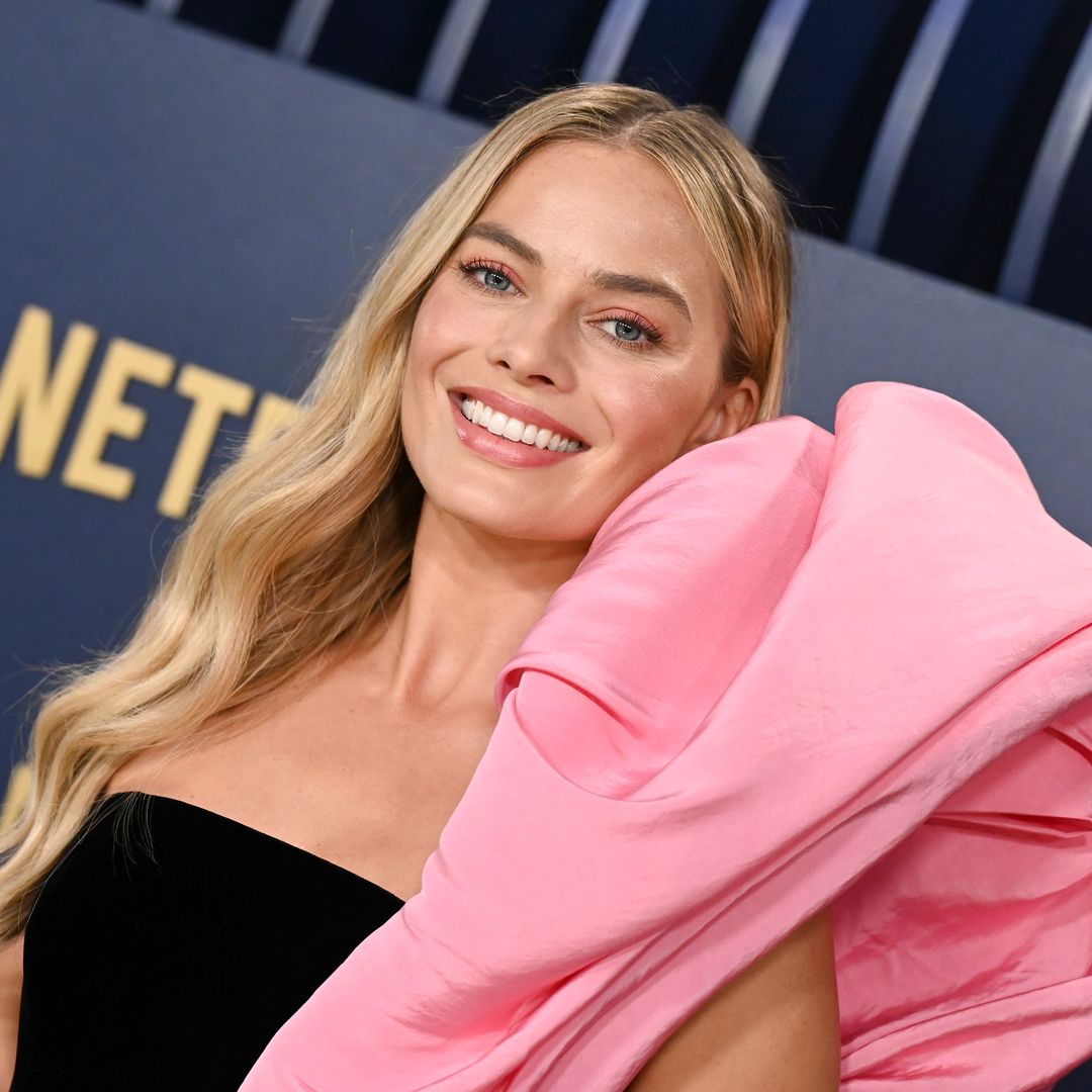 Margot Robbie proves pregnancy fashion needn't be boring in grey bodycon dress