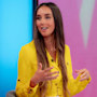 Pregnant Emily Andre glows in bump-defining dress and ultra-long princess hair
