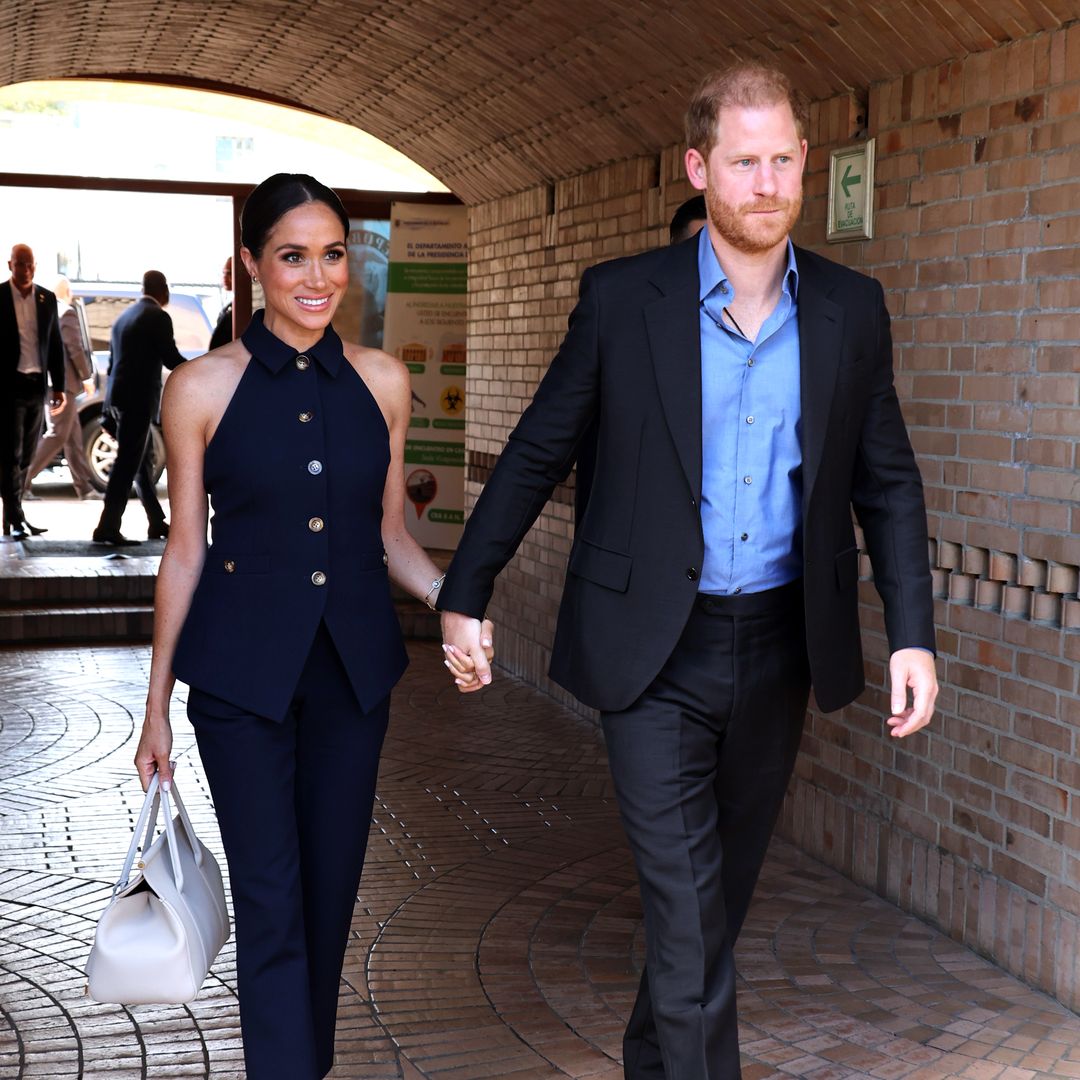 Prince Harry tenderly kisses wife Meghan in off-guard moment