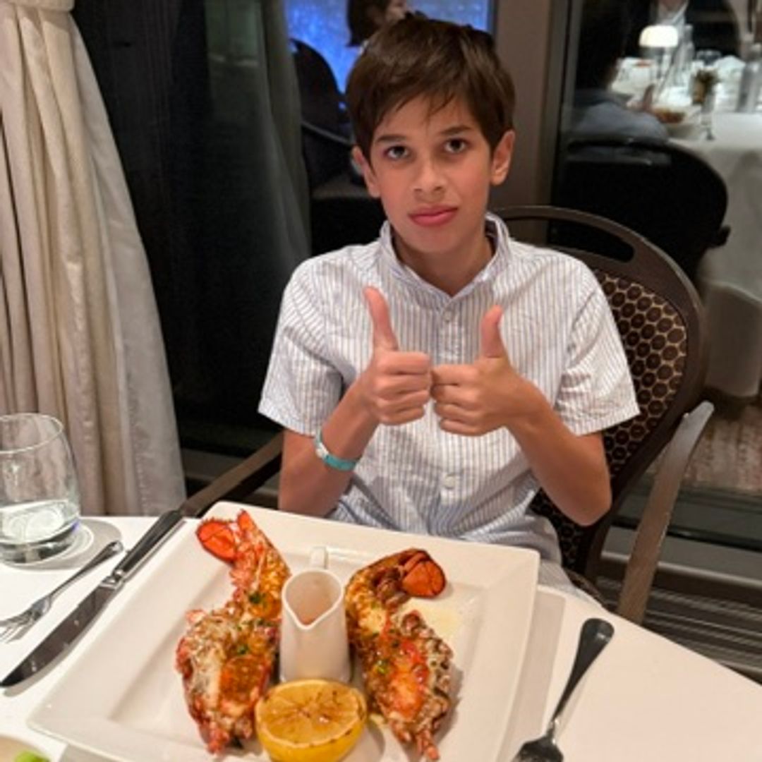 Boy eating lobster in the Epicurean restaurant on P&O cruise ship Azura