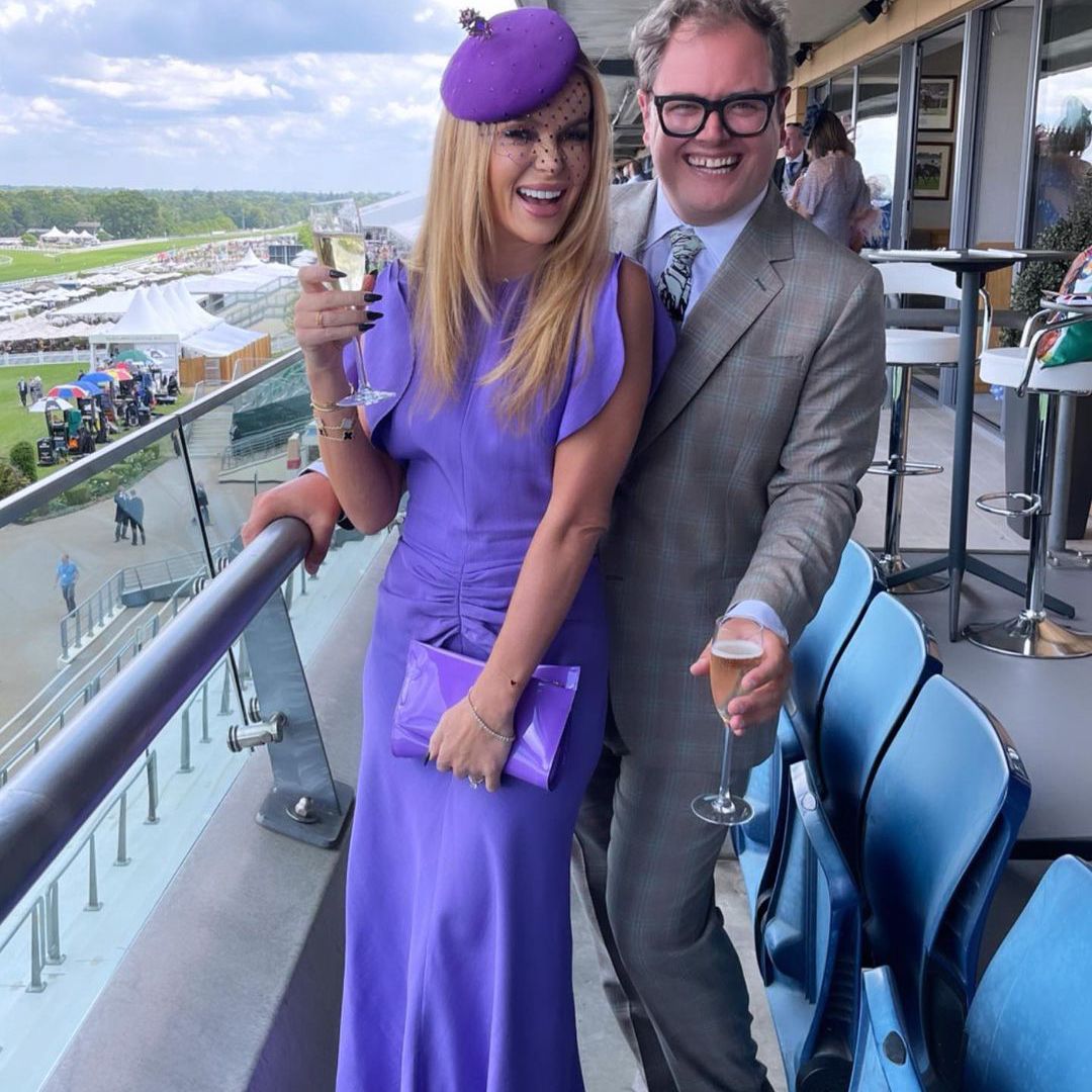 Amanda Holden poses with Alan Carr at Royal Ascot. She is wearing an £850 dress from Victoria Beckham's collection