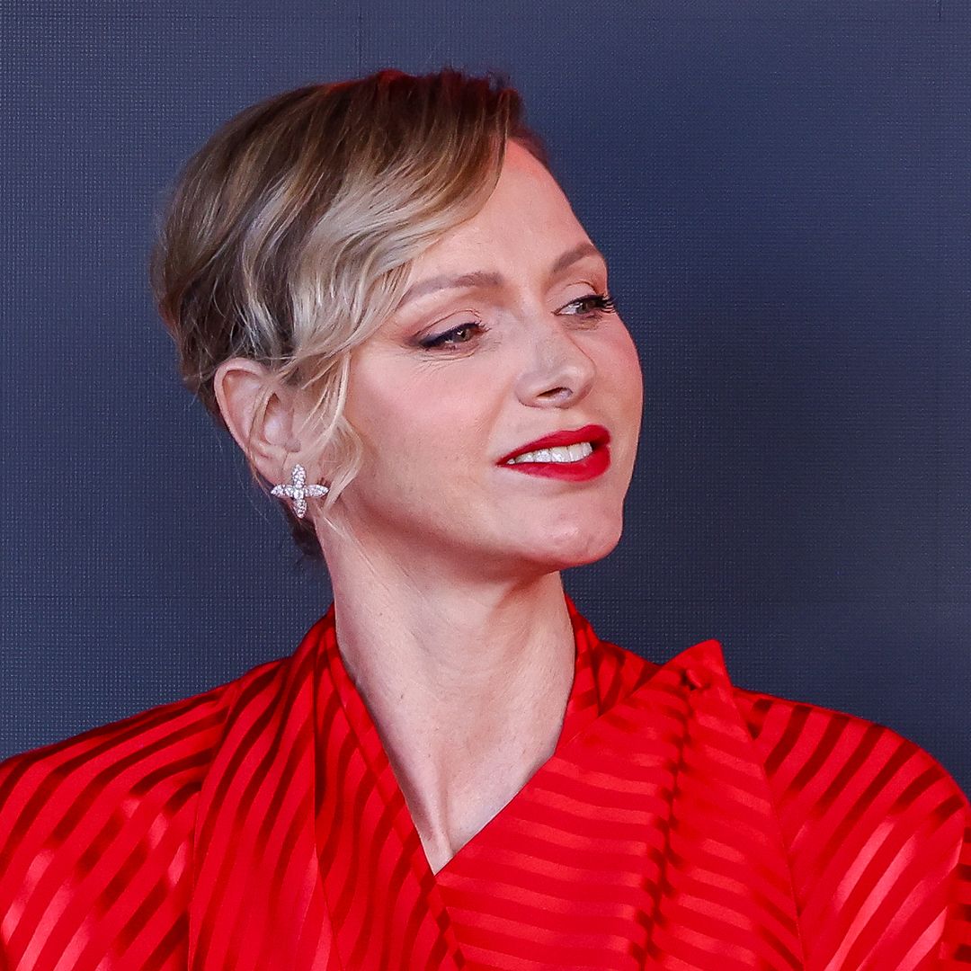 Princess Charlene is a scarlet siren in gorgeous form-fitting gown
