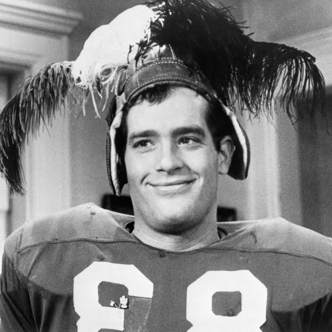 LIKE FATHER... Remind you of anyone? Well, Scott Newman, at left in this scene in the Paramount Pictures release, "Fraternity Row," is actor Paul Newman's son. Scott, 27, plays a "jock" in the movie about fraternity-sorority life in the early 1950s. It's his first major film role. He's been a professinal skydiver, a Hollywood stuntman and has had dramatic roles on television as well as a small part in "Breakheart Pass," a film that starred Charles Bronson. Undated, filed 2/11/1977.